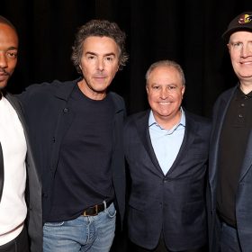 Anthony Mackie, Shawn Levy, Alan Bergman, Co-Chairman, Disney Entertainment, and Kevin Feige, President, Marvel Studios stand together for a group photo against a black backdrop.